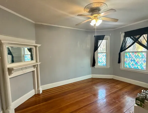 wooden floor in an empty room with a window