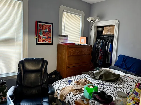 a bedroom with a bed and a chair