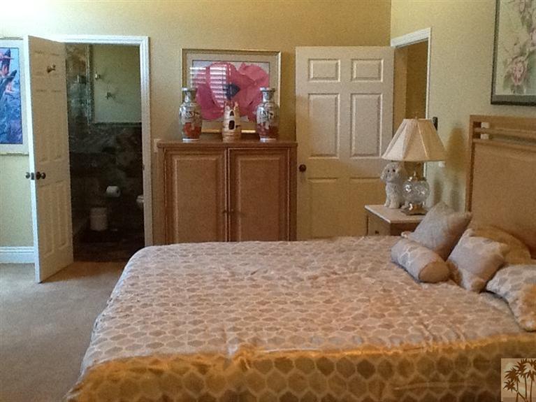 71936 Vista Del Rio Rancho Mirage, CA 92270 - Photo 13 of 17 a bedroom with a bed and a mirror