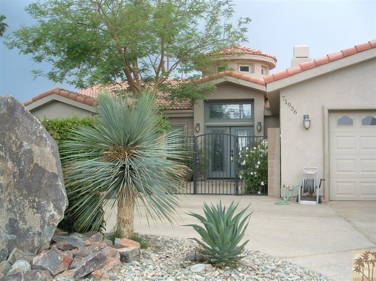 71936 Vista Del Rio Rancho Mirage, CA 92270 - Photo 4 of 17 a view of a wooden door and a tree in front