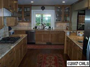 3326 Colony Road Charlotte, NC 28211 - Photo 4 of 8 a kitchen with granite countertop a sink stove and cabinets
