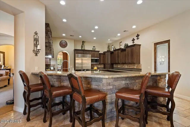 a bathroom with a tub and a chair