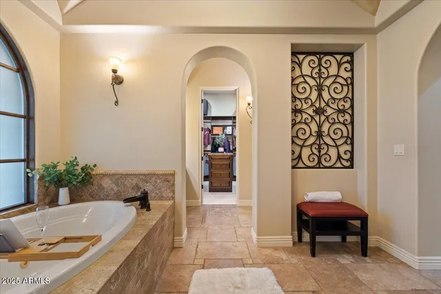 an aerial view of a house with a garden and lake view