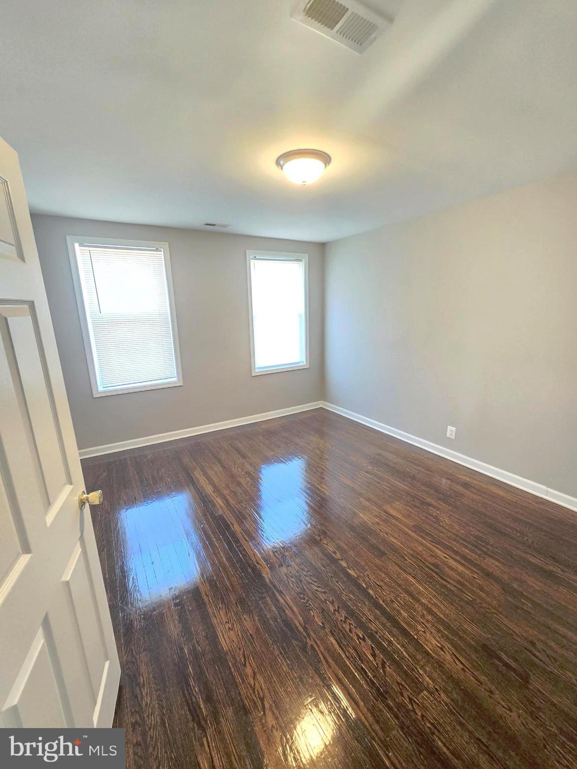 2805 Edison Highway Baltimore, MD 21213 - Photo 14 of 28 an empty room with wooden floor and windows