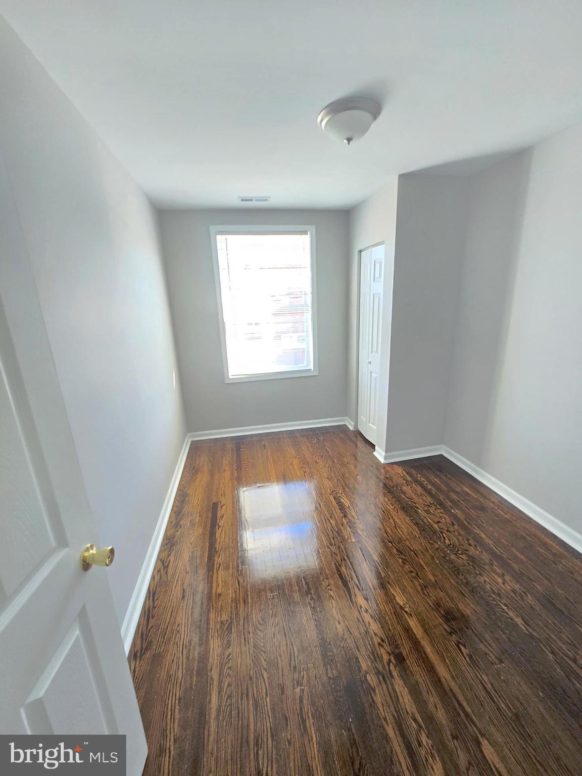 2805 Edison Highway Baltimore, MD 21213 - Photo 16 of 28 an empty room with wooden floor and windows