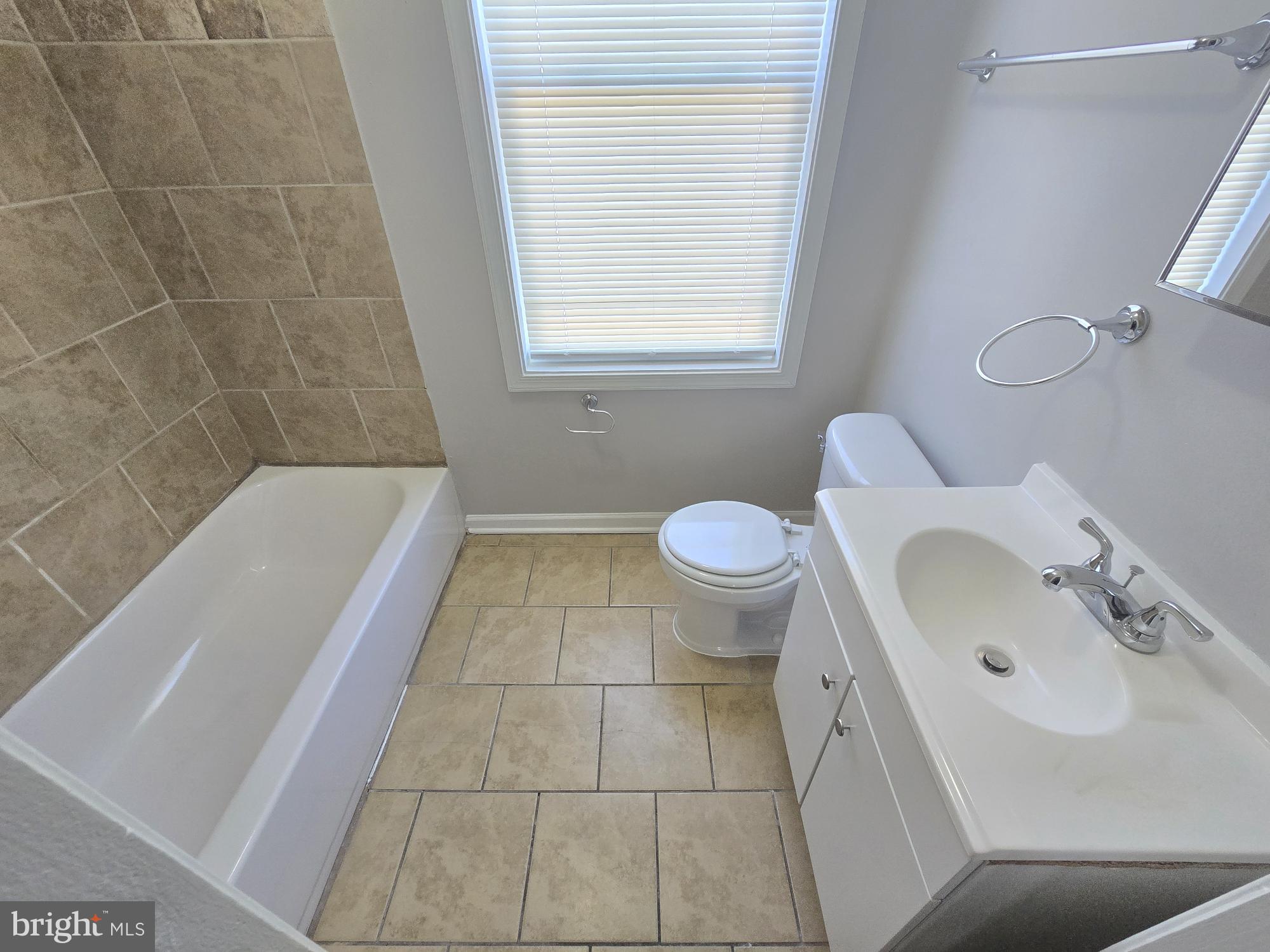 2805 Edison Highway Baltimore, MD 21213 - Photo 17 of 28 a bathroom with a sink a toilet and bathtub