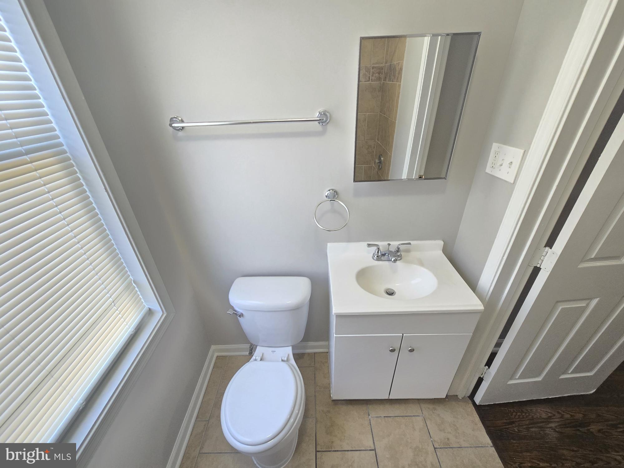 2805 Edison Highway Baltimore, MD 21213 - Photo 19 of 28 a bathroom with a toilet sink and mirror