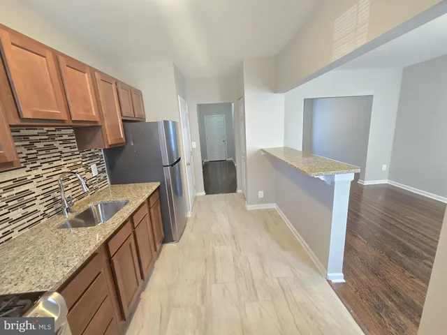 a kitchen with a sink stove and refrigerator