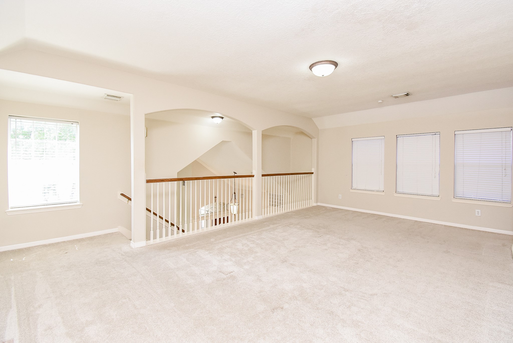 1714 Wellington Way Houston, TX 77055 - Photo 13 of 20 an empty room with windows and pillars in it