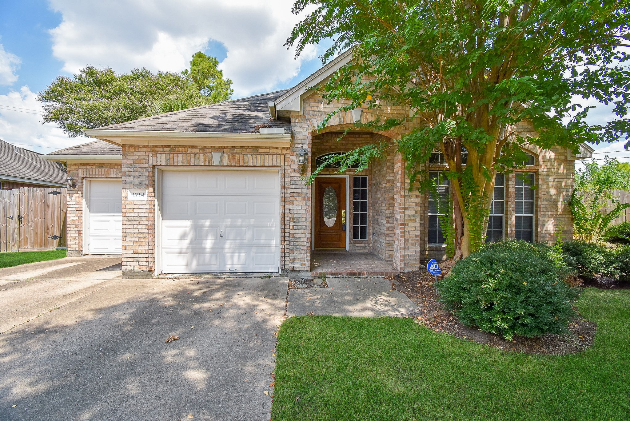 1714 Wellington Way Houston, TX 77055 - Photo 2 of 20 a front view of a house with a garden and yard