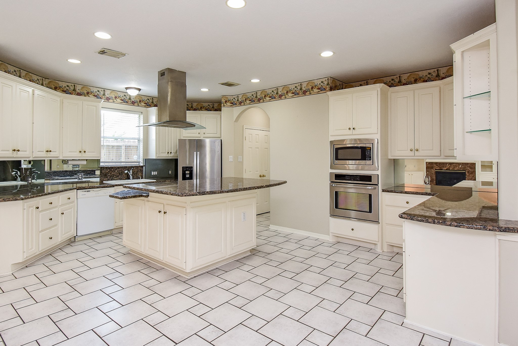 1714 Wellington Way Houston, TX 77055 - Photo 8 of 20 a kitchen with stainless steel appliances granite countertop a refrigerator sink and white cabinets