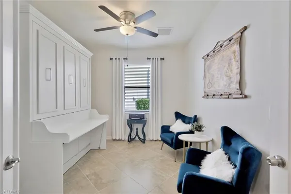 a view of a dining room with furniture one side kitchen view and wooden floor