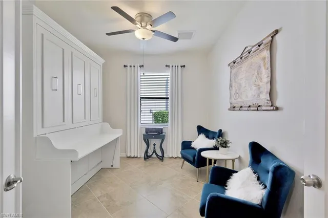 a view of a dining room with furniture one side kitchen view and wooden floor