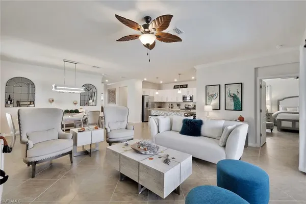 a living room with furniture and kitchen view