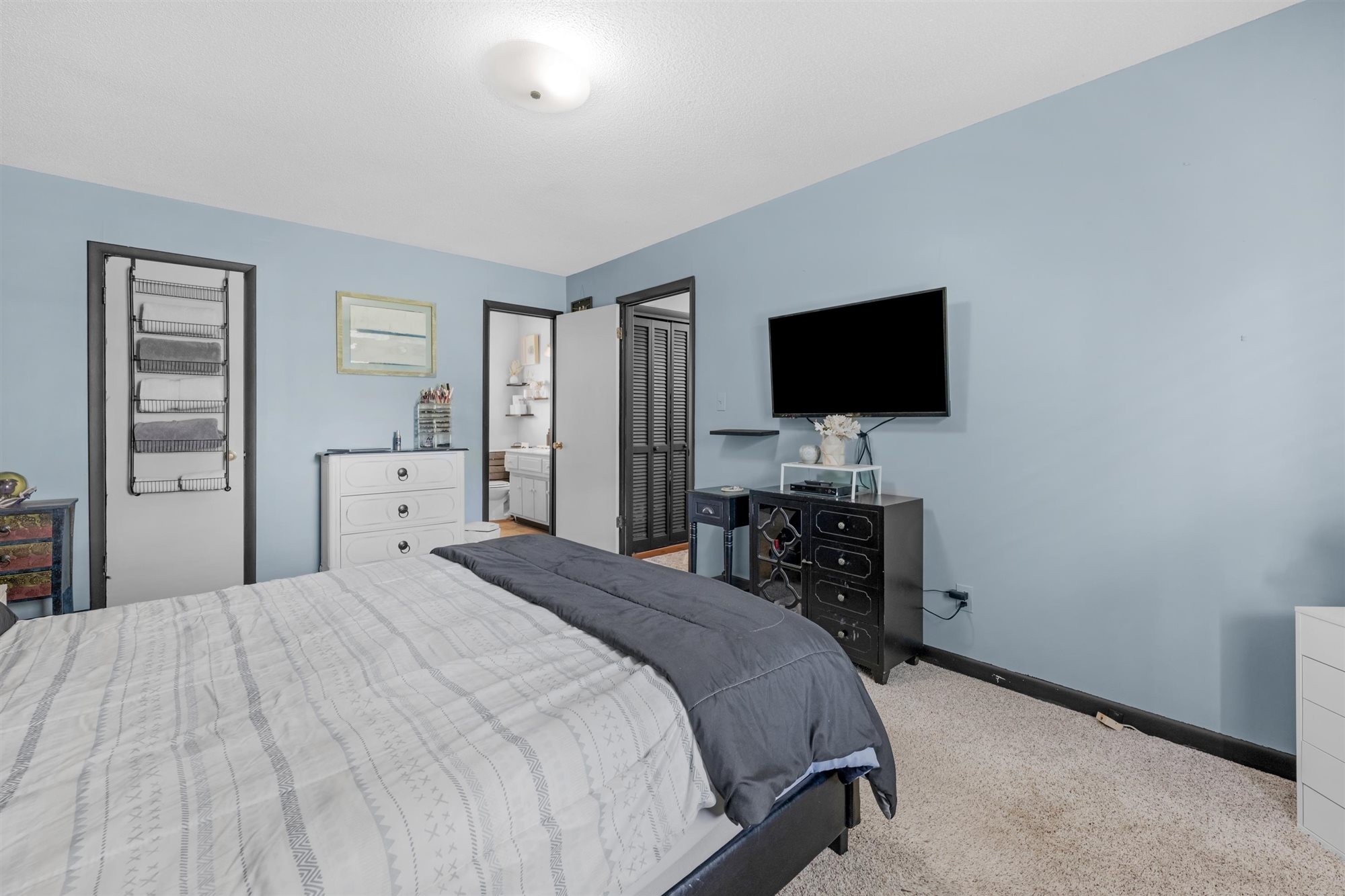 601 Courthouse View Street Lafayette, TN 37083 - Photo 16 of 25 a bedroom with a bed and a flat tv screen on wall