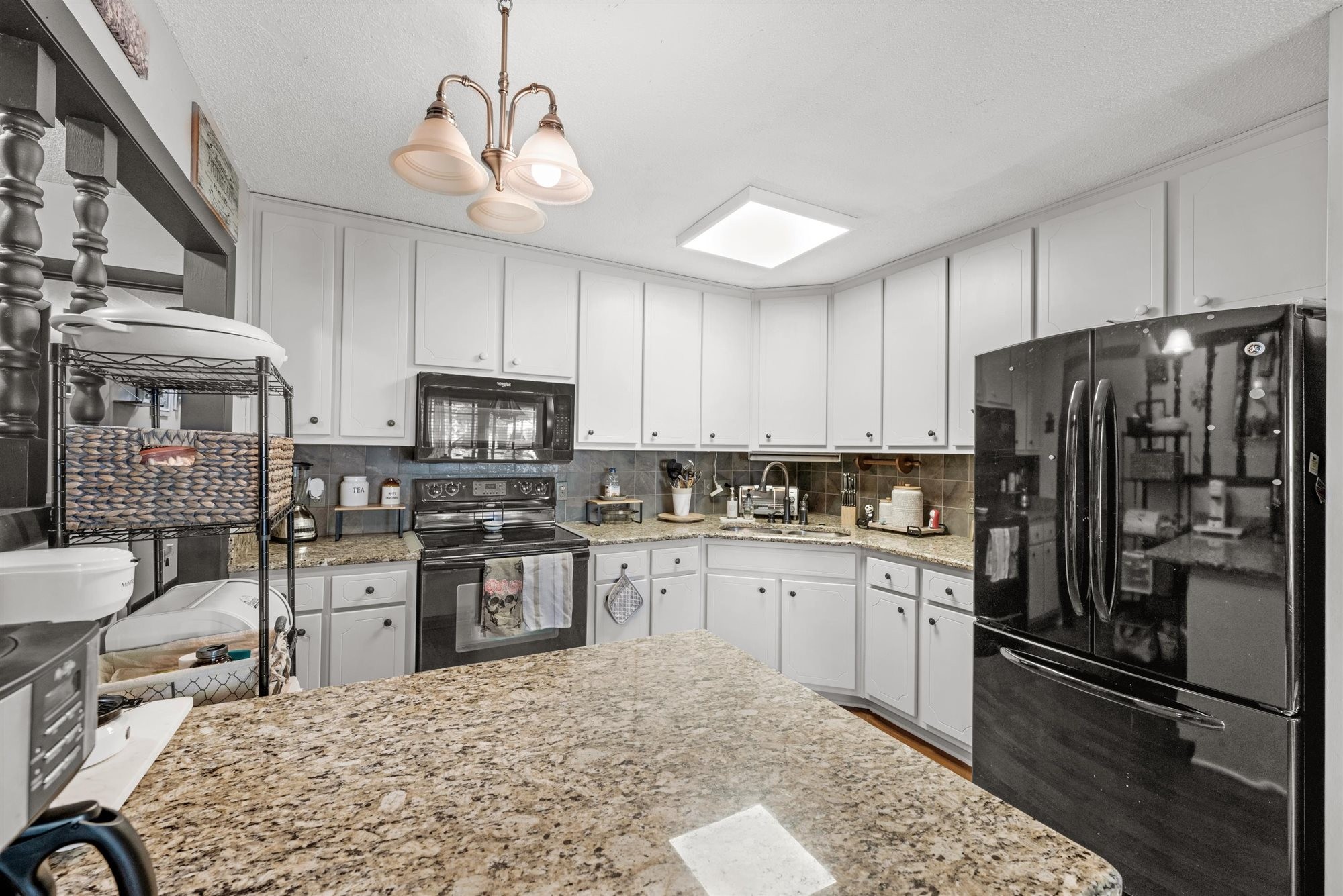 601 Courthouse View Street Lafayette, TN 37083 - Photo 19 of 25 a kitchen with stainless steel appliances granite countertop a refrigerator a sink dishwasher a stove top oven a refrigerator with island and chairs