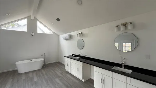 a room with a white cabinets and wooden floor