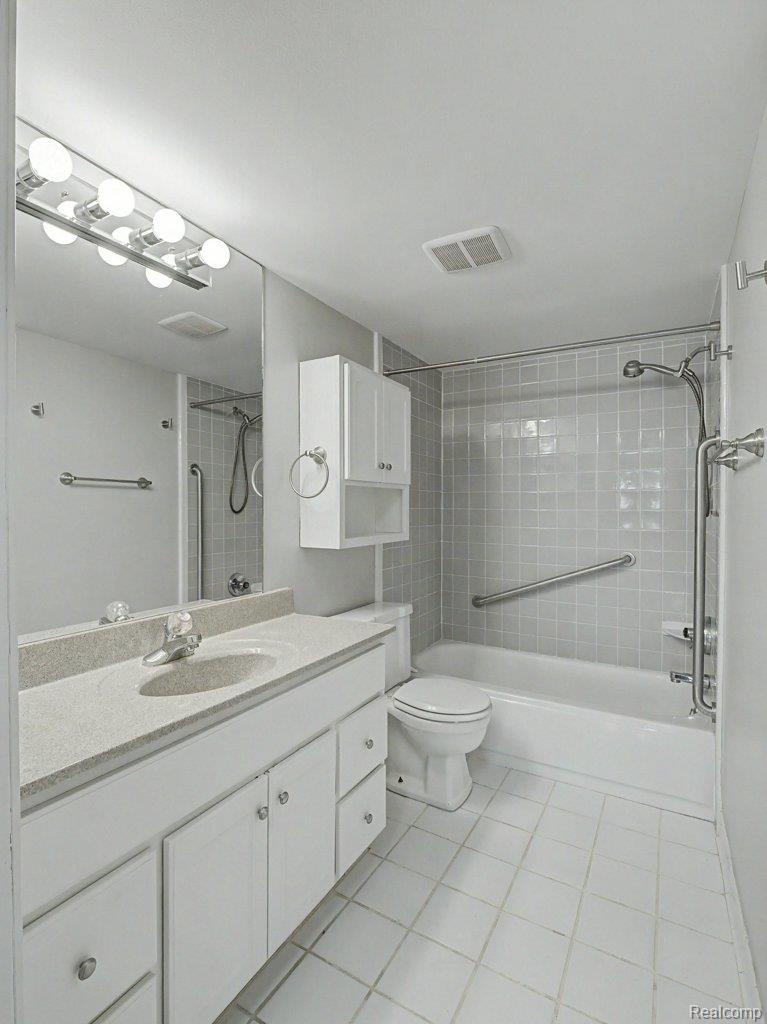 1974 Klingensmith Road, Unit 4 Bloomfield Hills, MI 48302 - Photo 21 of 35 Bathroom featuring a vanity with a light-colored countertop, integrated sink, and white cabinetry