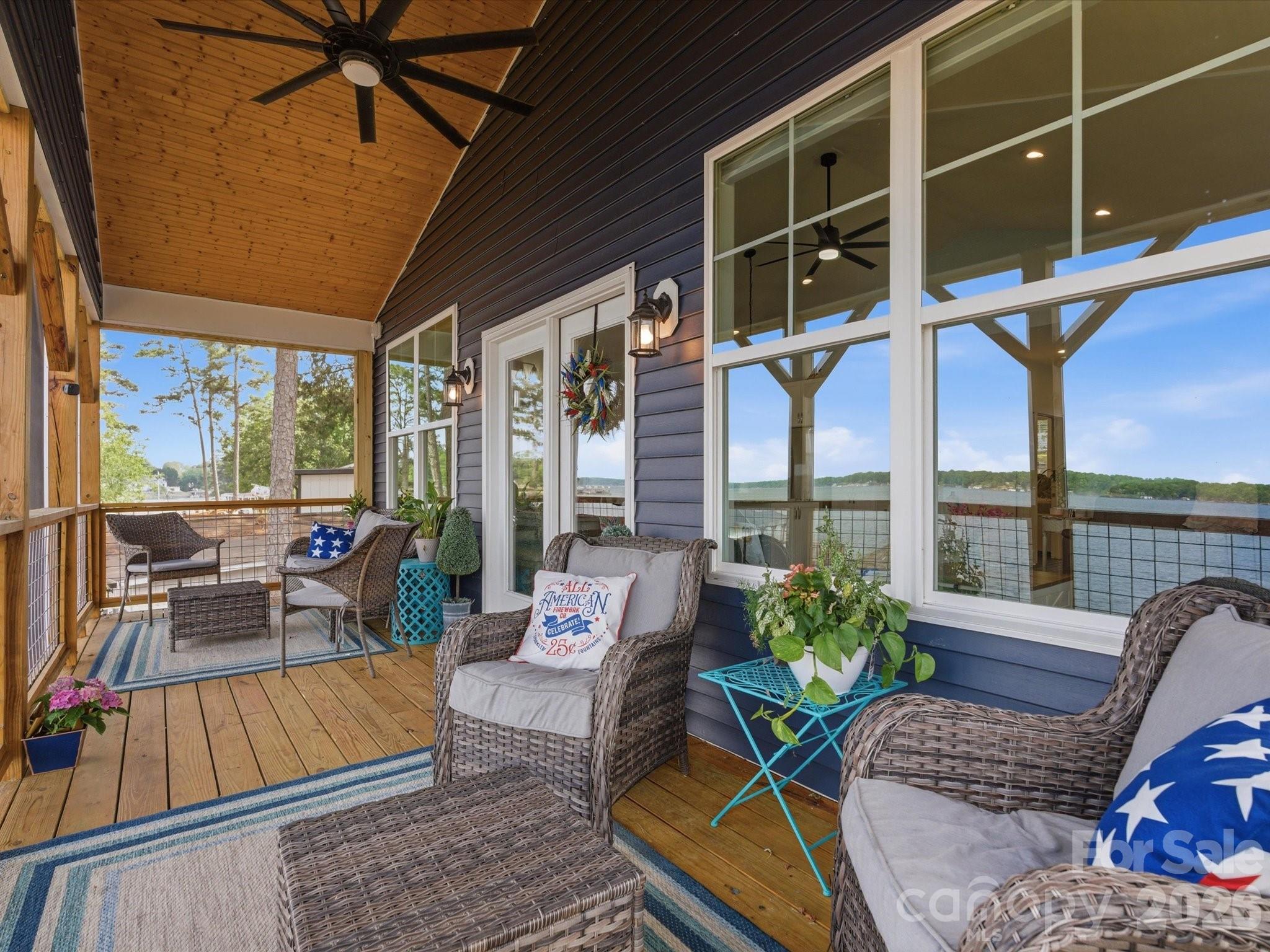 562 Lake Head Road Norwood, NC 28128 - Photo 7 of 43 a living room with furniture and floor to ceiling windows