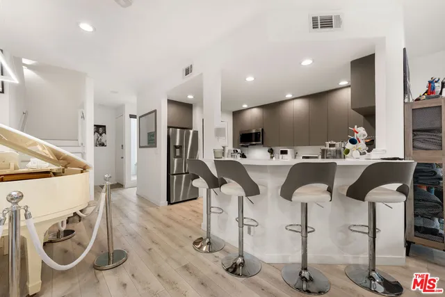 a large kitchen with a table and chairs