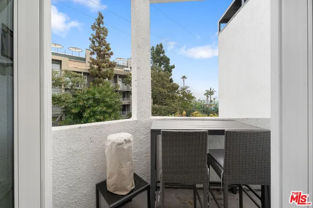 a view of a balcony with chairs
