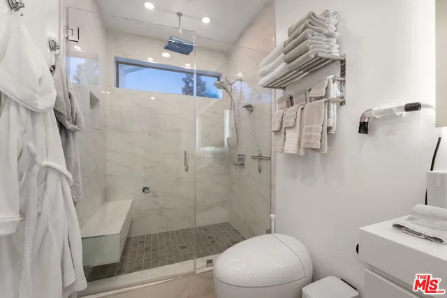 a bathroom with a shower toilet and sink