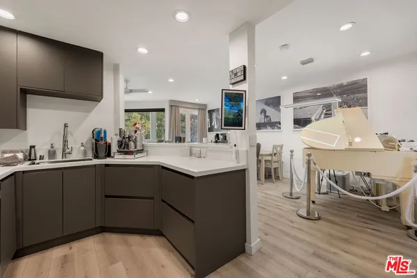 a kitchen with stainless steel appliances kitchen island granite countertop a sink and cabinets