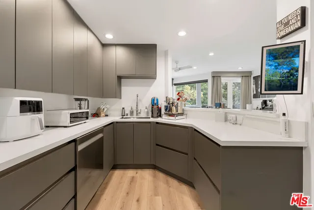 a kitchen with a sink cabinets and window