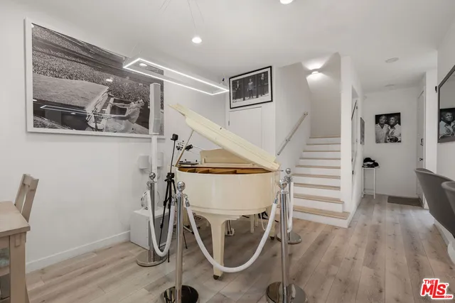 a view of a room with wooden floor and windows