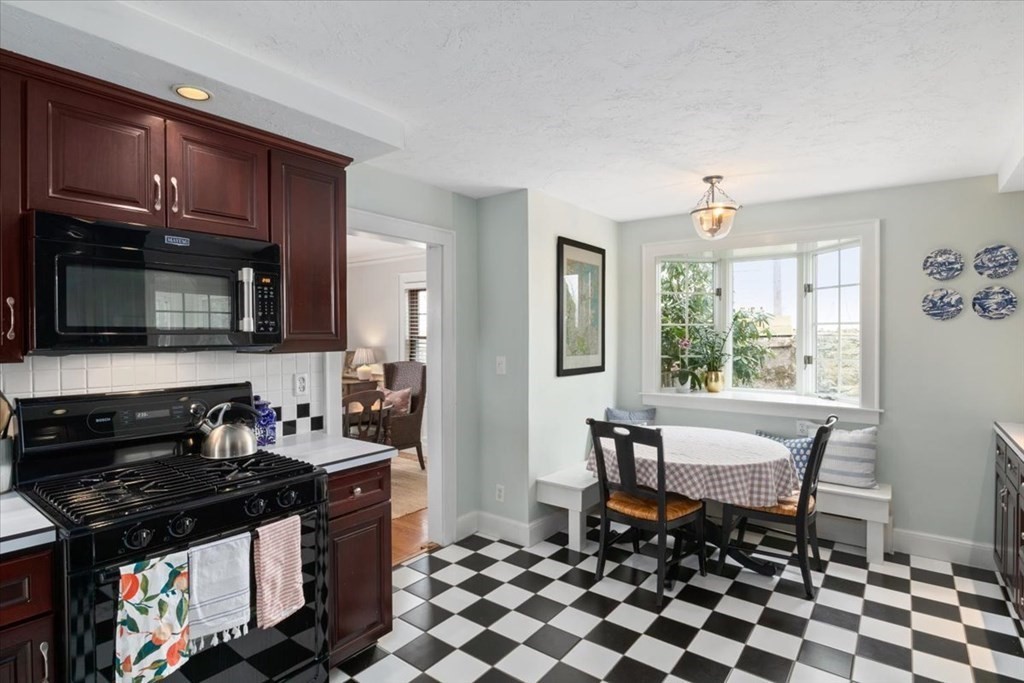16 Sturges Road Boston, MA 02132 - Photo 12 of 34 a kitchen with granite countertop a stove a sink and a microwave