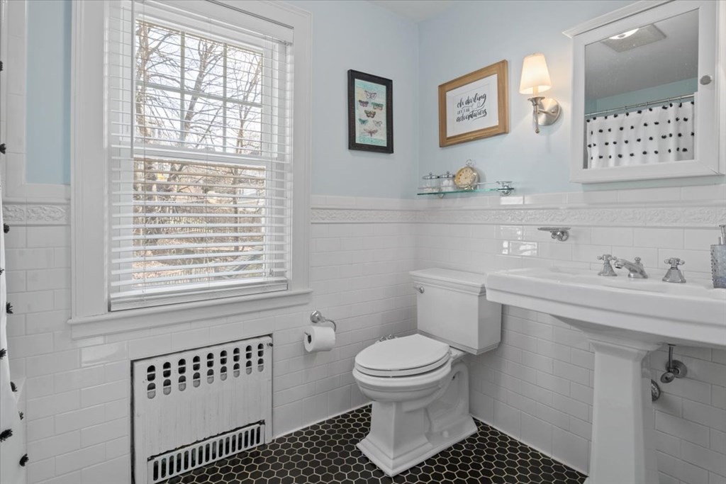 16 Sturges Road Boston, MA 02132 - Photo 21 of 34 a bathroom with a toilet a sink and a window