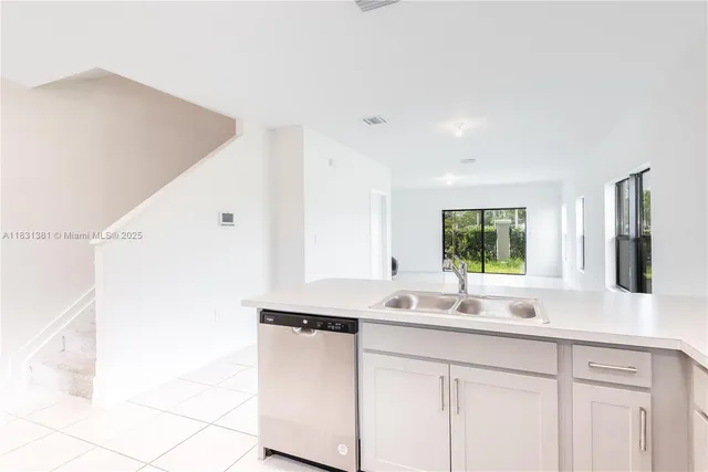 a view of white house with a swimming pool