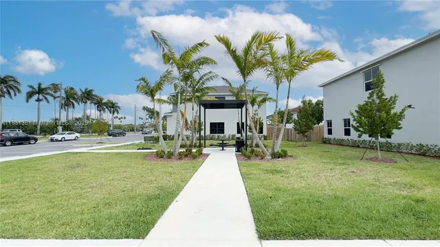 a view of a kitchen with furniture and an empty room