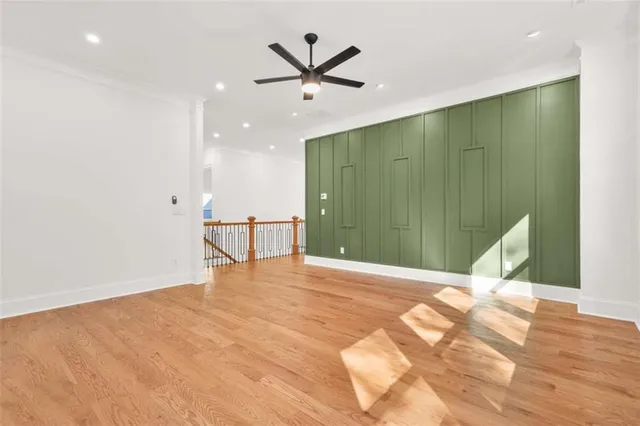 a view of a livingroom with a ceiling fan and kitchen space