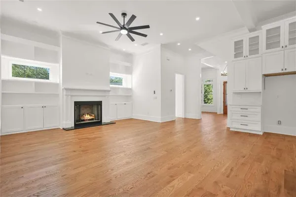 a view of empty room with wooden floor