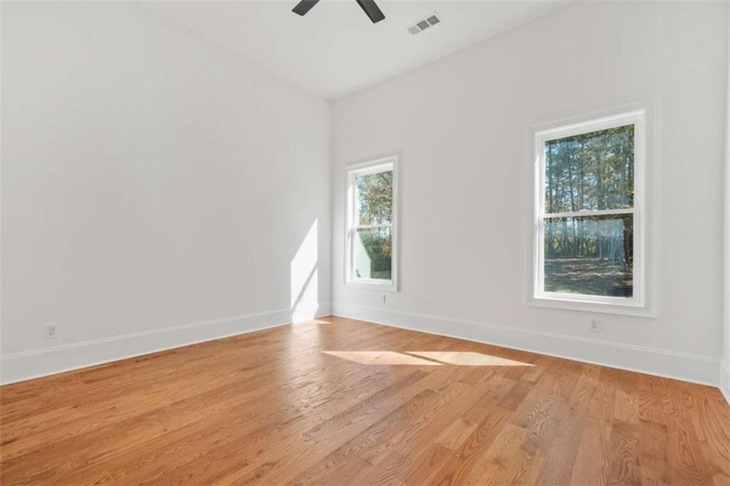 1525 Tapestry Ridge Southeast Lawrenceville, GA 30045 - Photo 29 of 49 an empty room with wooden floor and windows