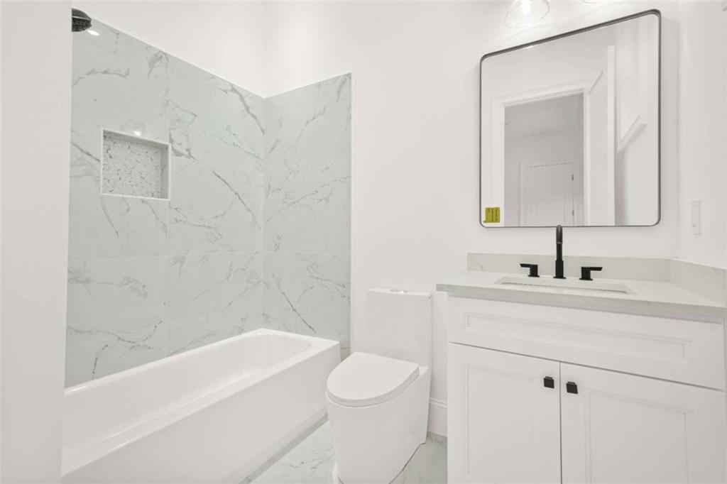 1525 Tapestry Ridge Southeast Lawrenceville, GA 30045 - Photo 32 of 49 a bathroom with a sink a toilet and shower