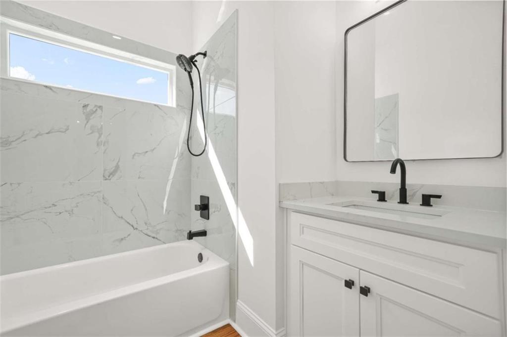 1525 Tapestry Ridge Southeast Lawrenceville, GA 30045 - Photo 34 of 49 a bathroom with a tub sink and mirror