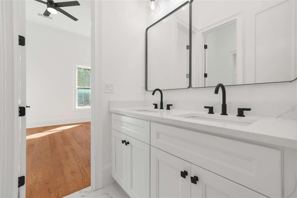 1525 Tapestry Ridge Southeast Lawrenceville, GA 30045 - Photo 39 of 49 a bathroom with a double vanity sink and mirror