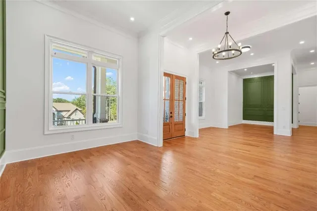 a view of an empty room with window and fire place