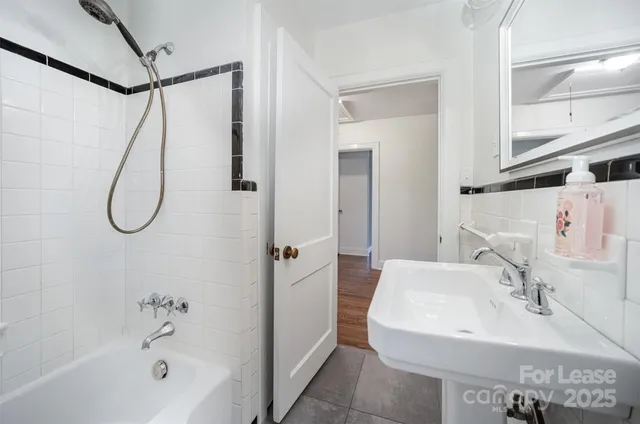 a bathroom with a sink a mirror and a shower