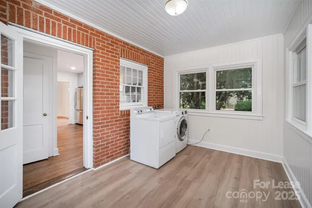 an entryway with wooden floor and windows