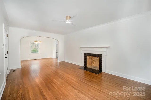 an empty room with wooden floor and cabinet