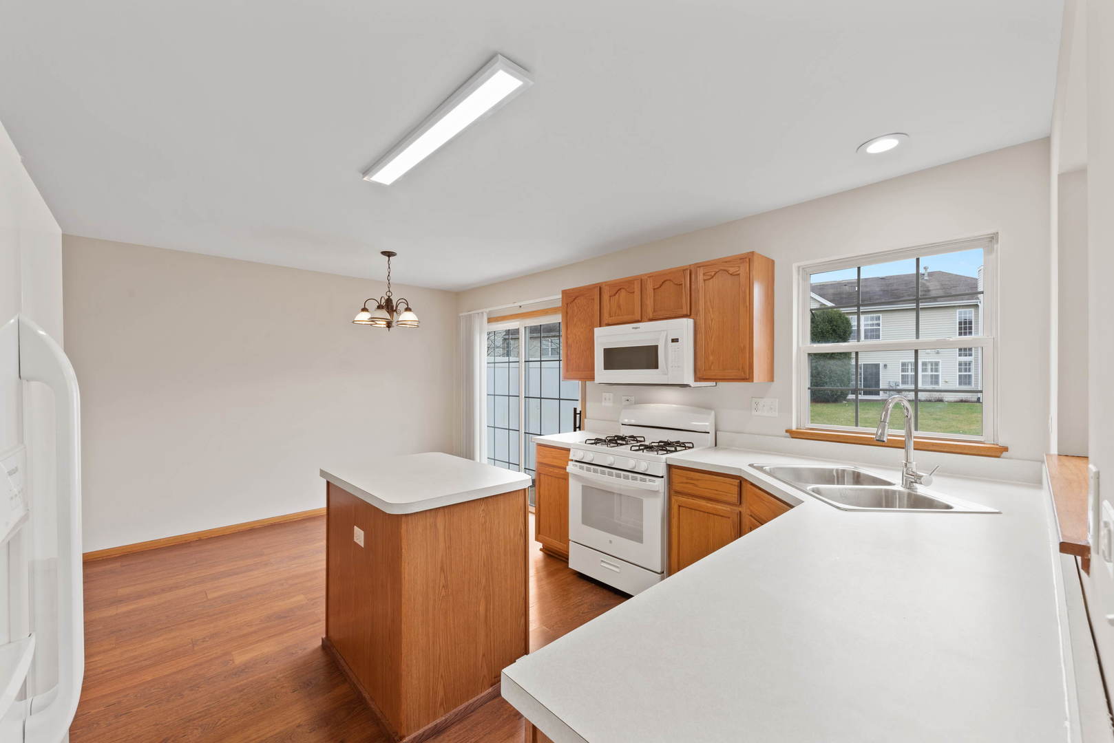 2267 Scott Lane Aurora, IL 60502 - Photo 12 of 22 a kitchen with stainless steel appliances granite countertop a sink stove and refrigerator