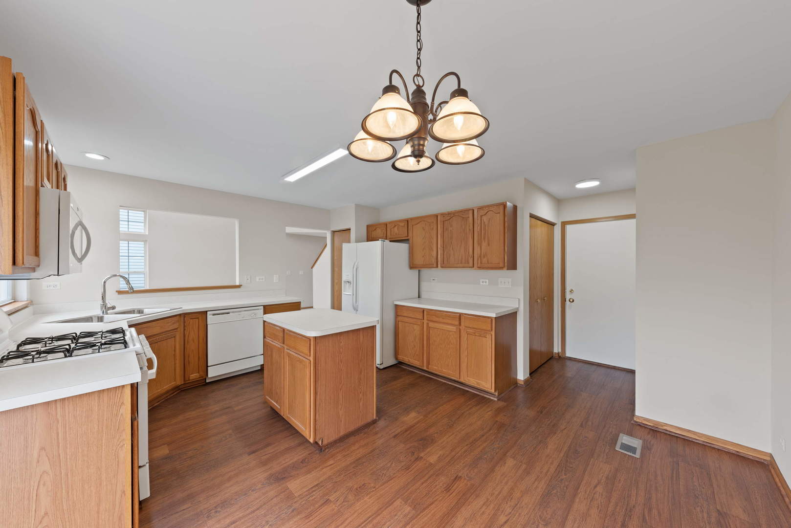 2267 Scott Lane Aurora, IL 60502 - Photo 13 of 22 a kitchen with stainless steel appliances granite countertop a stove and wooden floor