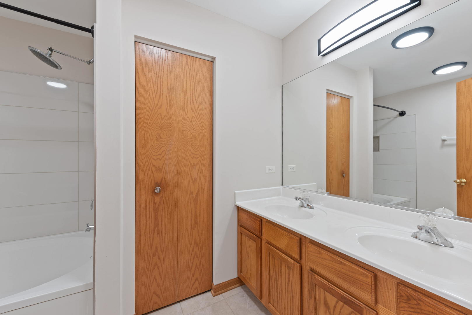 2267 Scott Lane Aurora, IL 60502 - Photo 17 of 22 a spacious bathroom with a double vanity sink a mirror and a bathtub