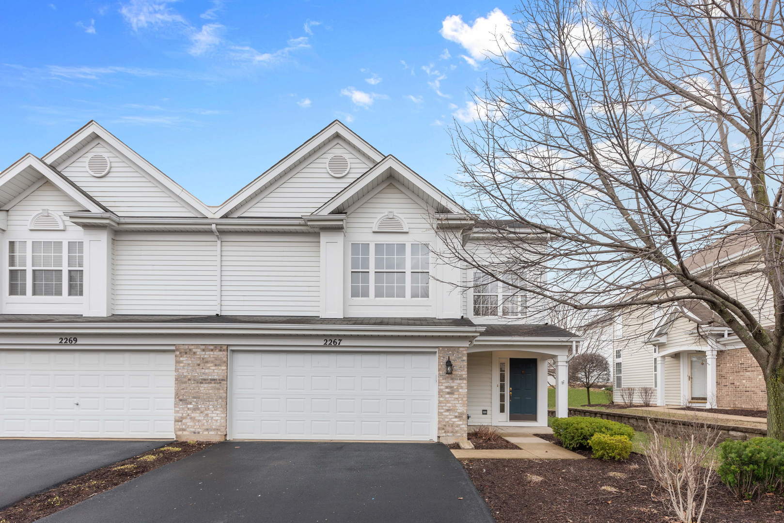 2267 Scott Lane Aurora, IL 60502 - Photo 2 of 22 a view of a white house with large windows and a tree