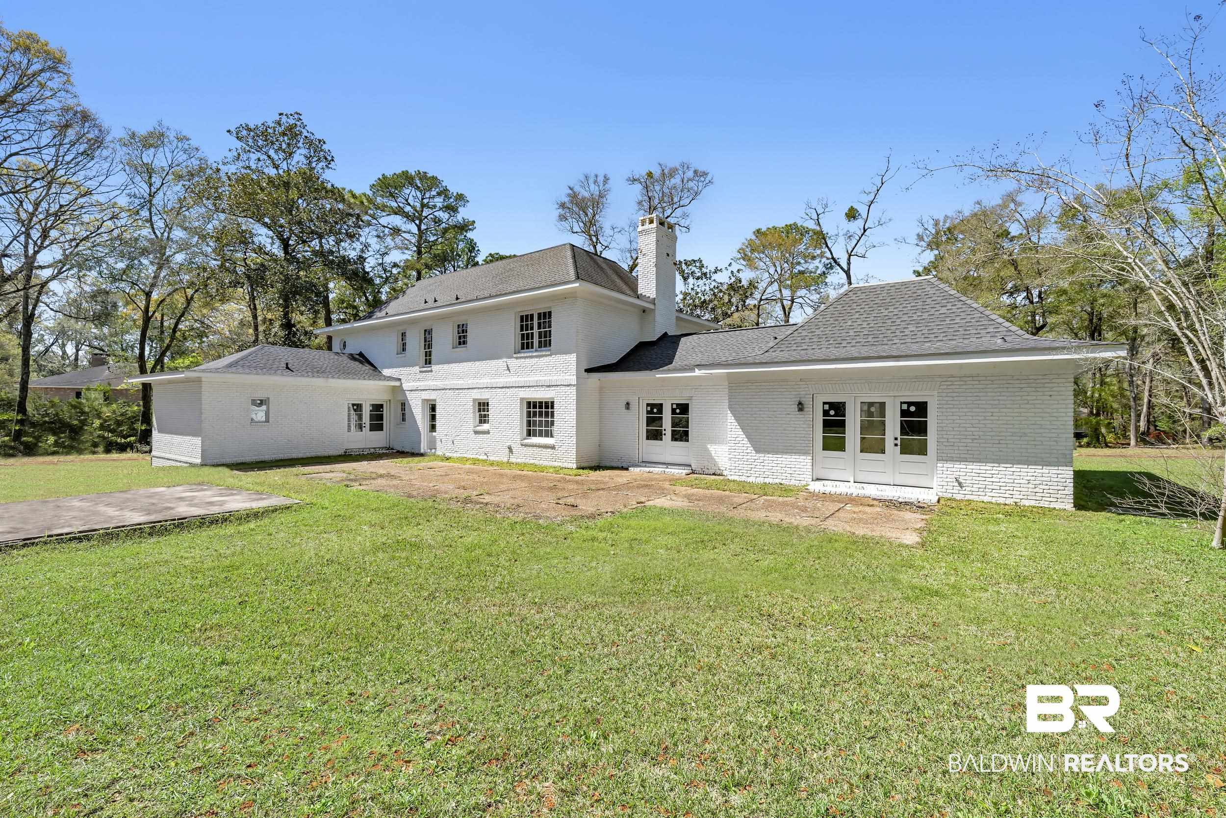 5801 South Fairfax Road Mobile, AL 36608 - Photo 5 of 29 Back of house with a chimney, a lawn, brick siding, and a patio
