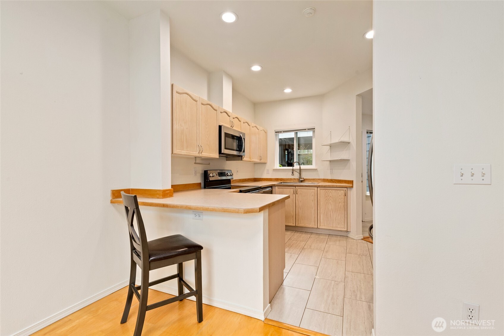 22619 4th Avenue West, Unit 3103 Bothell, WA 98021 - Photo 5 of 26 a kitchen with a sink a counter top space cabinets and stainless steel appliances
