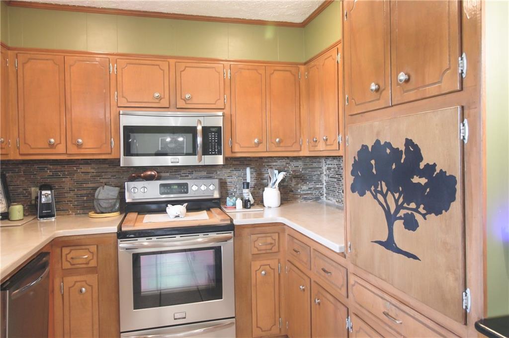 249 Cooper Road Southeast Calhoun, GA 30701 - Photo 17 of 62 a kitchen with a stove and a microwave
